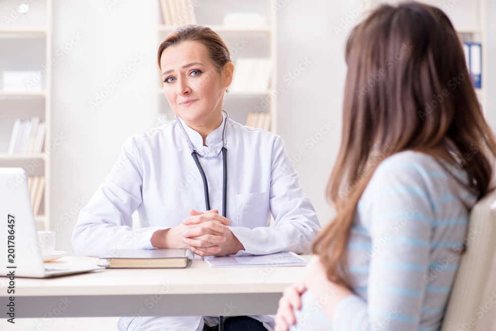 Pregnant woman visiting doctor for regular check-up