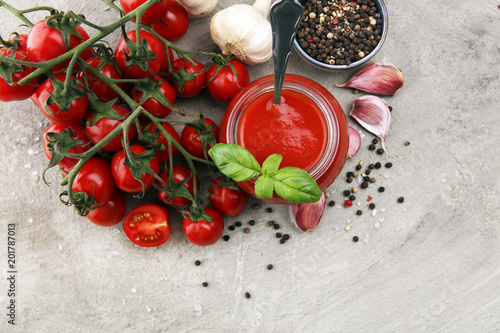 Fresh cherry tomato sauce on rustic background with cherry tomatoes.