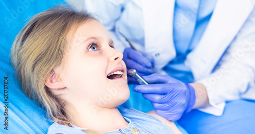 Little girl sitting in the dentists office