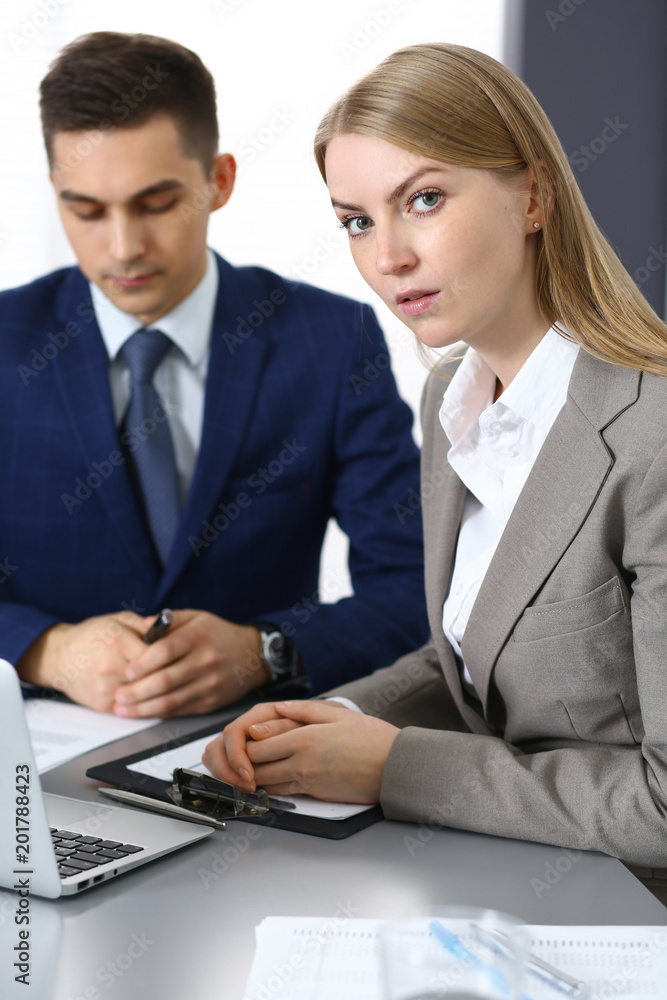 Business people using laptop pc while discussing project in office Business people using laptop pc while discussing project in office