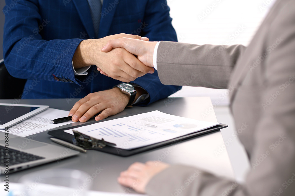 Business people shaking hands, finishing up a meeting. Papers signing, agreement and lawyer consulting concept Business people shaking hands, finishing up a meeting. Papers signing, agreement and lawyer consulting concept