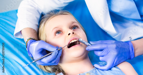 Little girl sitting in the dentists office