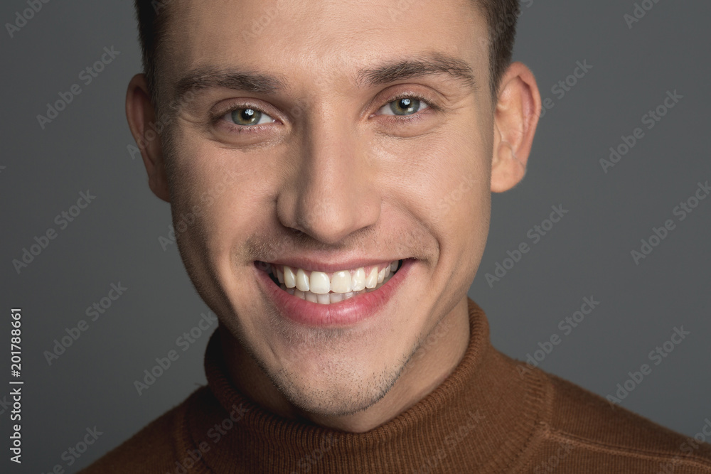 Obraz premium Portrait of young male person with groomed skin and white smile. Isolated on background