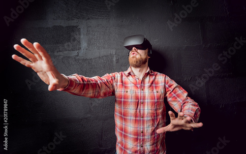 The young man wearing virtual reality goggles © romaset
