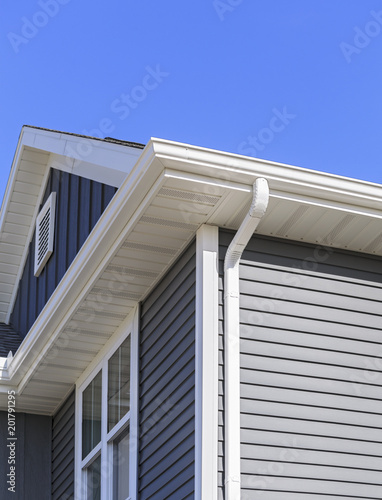 Grey siding, gutters, and soffit on a new home