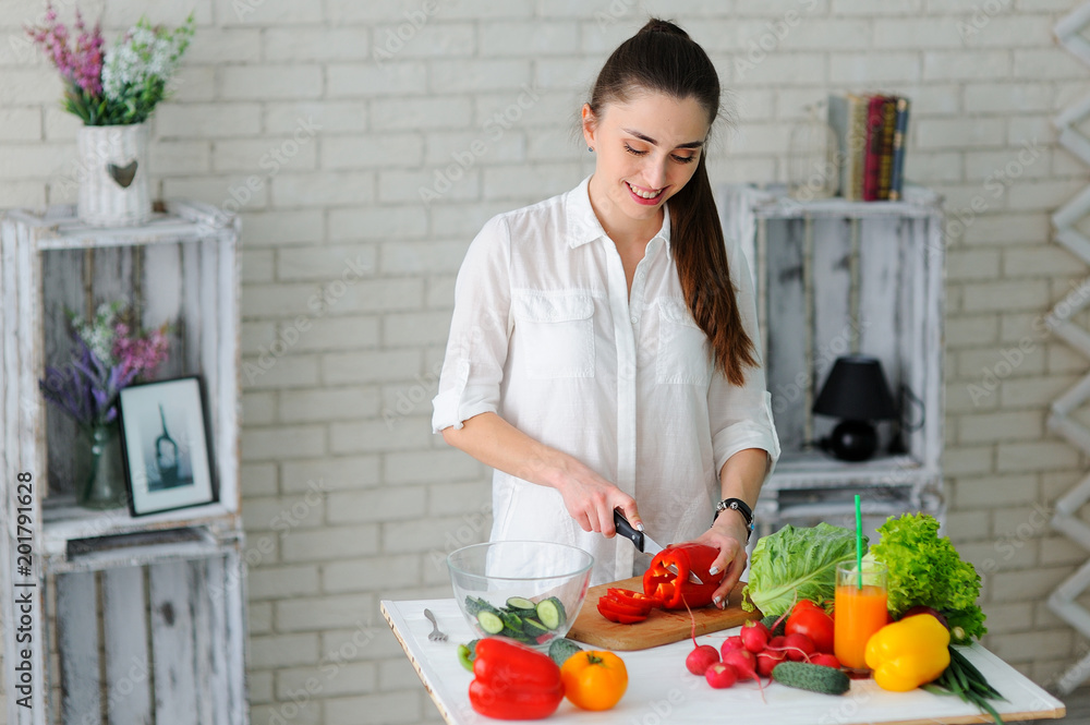 Young Woman Cooking. Healthy Food - Vegetable Salad. Diet. Healthy Lifestyle. Cooking At Home. Prepare Food Young Woman Cooking. Healthy Food - Vegetable Salad. Diet. Healthy Lifestyle. Cooking At Home. Prepare Food