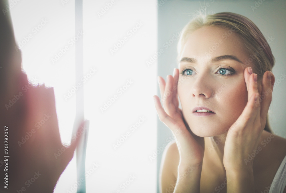 face of young beautiful healthy woman and reflection in the mirror face of young beautiful healthy woman and reflection in the mirror
