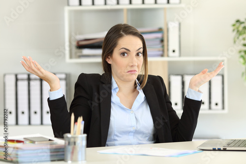 Confused businesswoman looking at camera