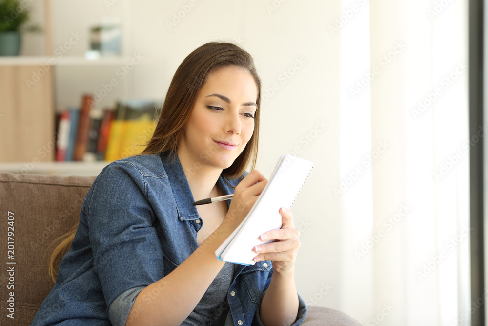 Serious girl writing in a notebook at home Serious girl writing in a notebook at home