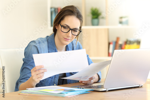 Canvas Print Self employed working comparing documents at home