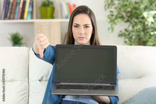 Anwry woman showing a blank laptop screen