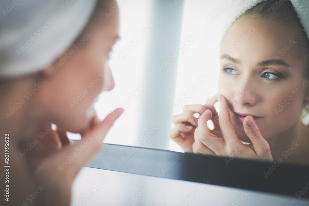 face of young beautiful healthy woman and reflection in the mirror face of young beautiful healthy woman and reflection in the mirror