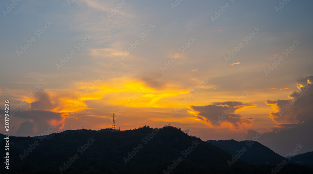 Orange blue sky and clouds above the mountain. Morning  sky with clouds and sun