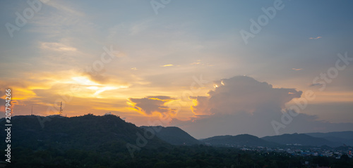 Orange blue sky and clouds above the mountain. Morning sky with clouds and sun