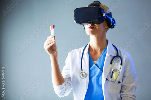 Female doctor wearing virtual reality glasses isolated on white background.