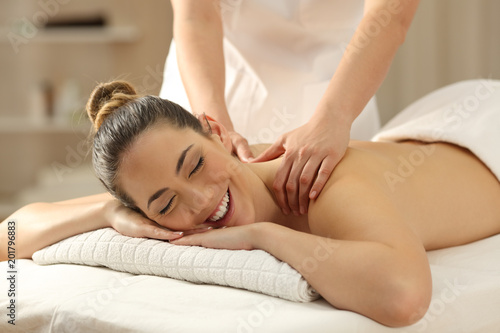 Happy woman receiving a massage in a spa