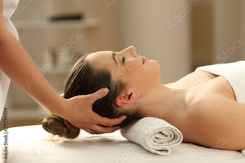 Woman receiving a head massage in a spa photo