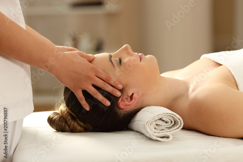 Woman relaxing receiving a facial massage