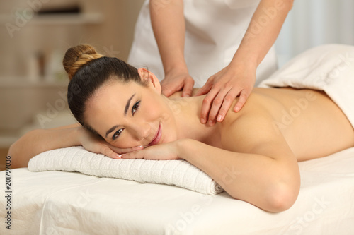 Woman receiving a massage looking at you