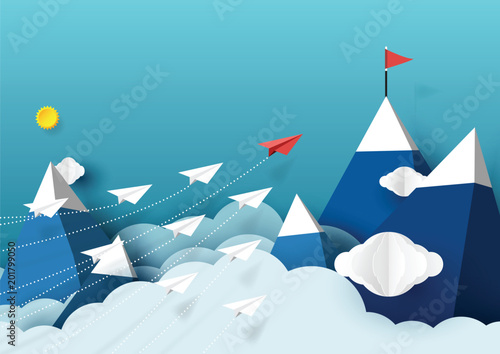 Paper airplanes flying above mountains and blue sky.Paper art style of business teamwork creative concept idea.