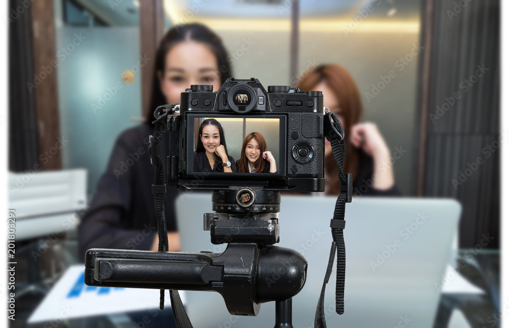 Professional digital Mirrorless camera with microphone recording video blog of Two Asian young Businesswoman, Camera for photographer or Video and Live Streaming concept