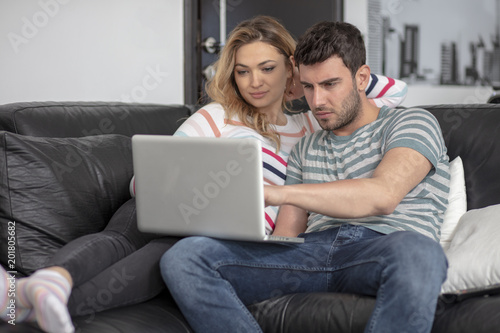 Joyful husband and wife relaxing at home