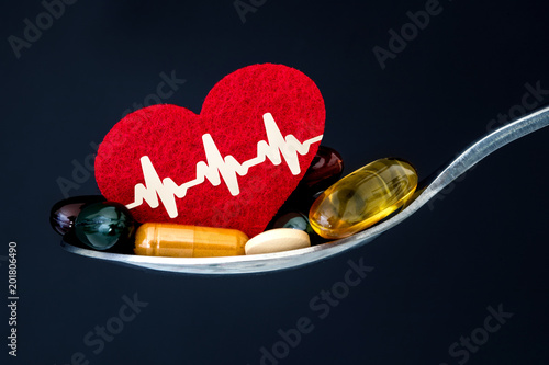 Obraz na plátně the colorful medical supplement and drug pills with red heart in spoon , pharmac