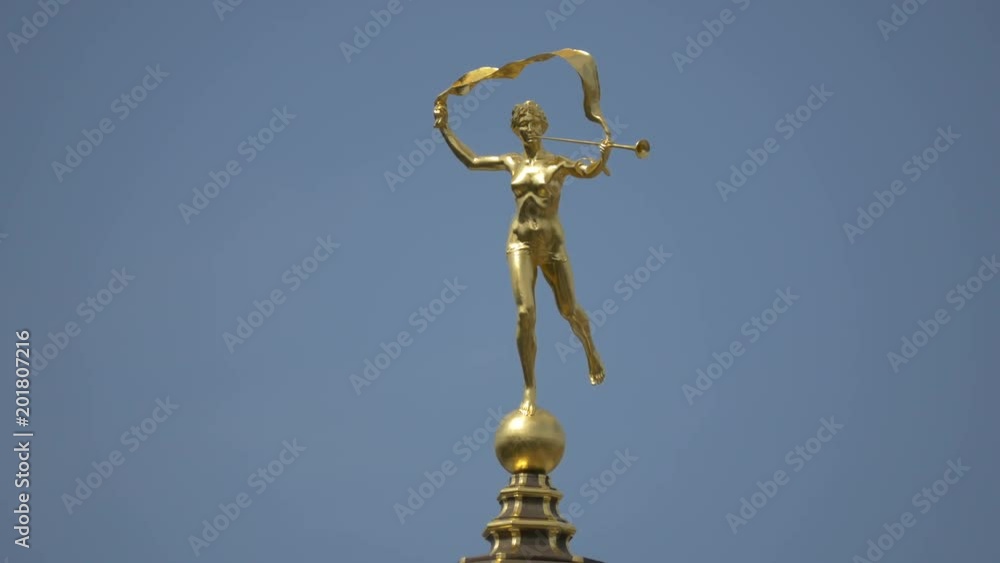 Gilded statue on top of a building Gilded statue on top of a building