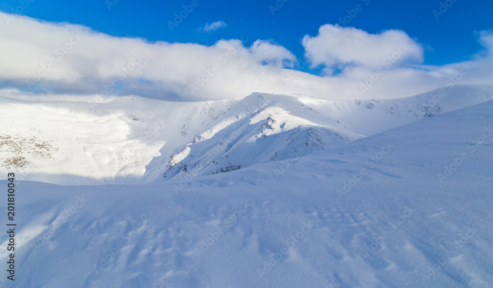 Beautiful winter scenery in the mountains, with fresh snow, and mist, on a bright sunny day Beautiful winter scenery in the mountains, with fresh snow, and mist, on a bright sunny day