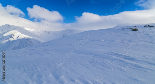 Beautiful winter scenery in the mountains, with fresh snow, and mist, on a bright sunny day