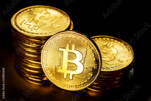 Shiny physical bitcoins on black background. Blockchain technology.