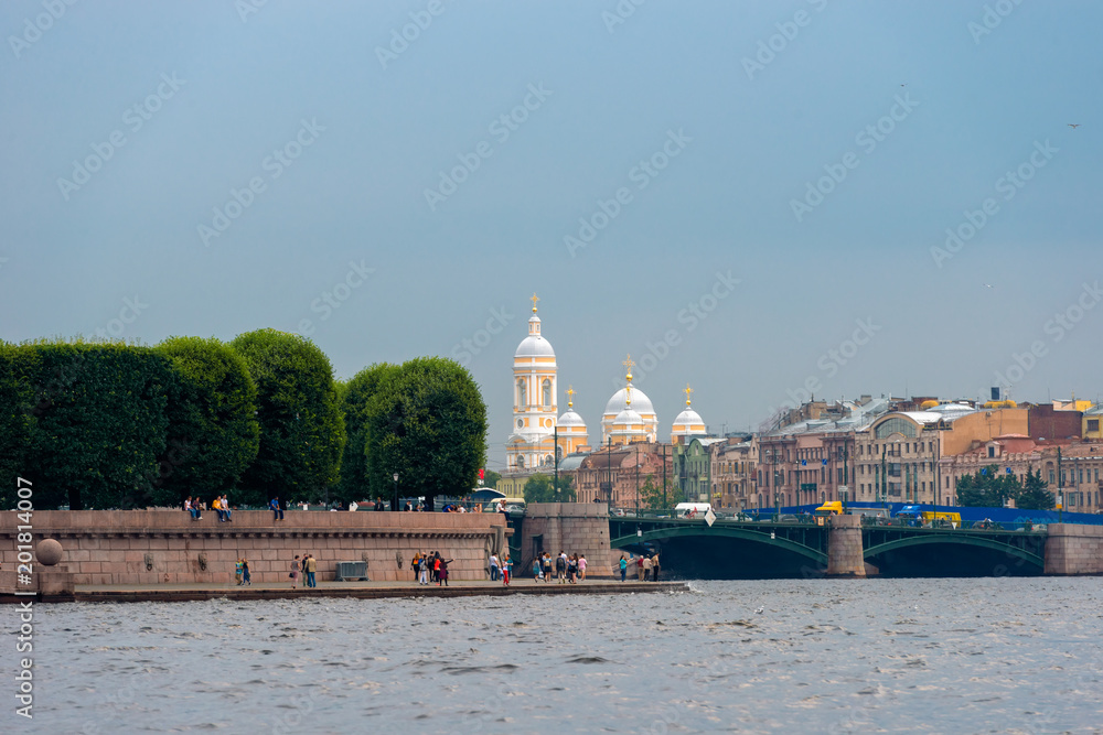 RUSSIA, SAINT PETERSBURG - AUGUST 18, 2017: View from the Neva River to Strelka of the Vasilievsky Island, the Exchange Bridge and the Prince Vladimirsky Cathedral