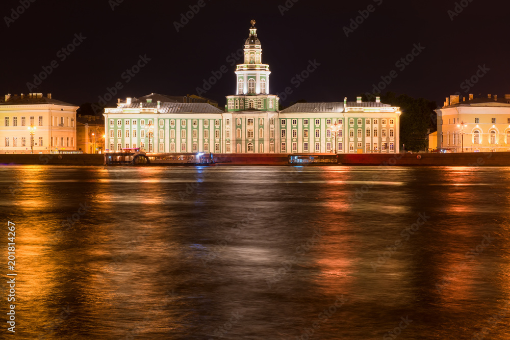RUSSIA, SAINT PETERSBURG - AUGUST 18, 2017: University Embankment house 3 with the building of the Cabinet of curiosities  in a dark summer night