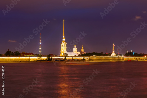 RUSSIA, SAINT PETERSBURG - AUGUST 18, 2017: View on the Peter and Paul Fortress, the river Neva, the steeple with a cross on a dark summer night