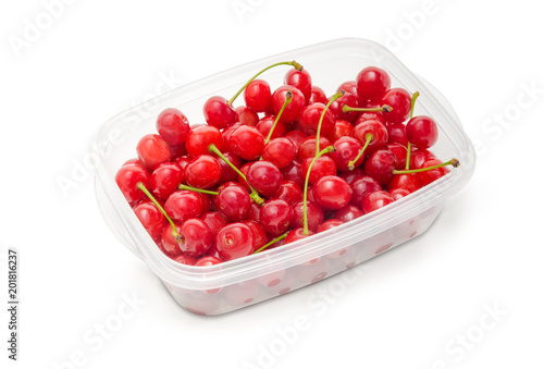 Washed red cherries in plastic container