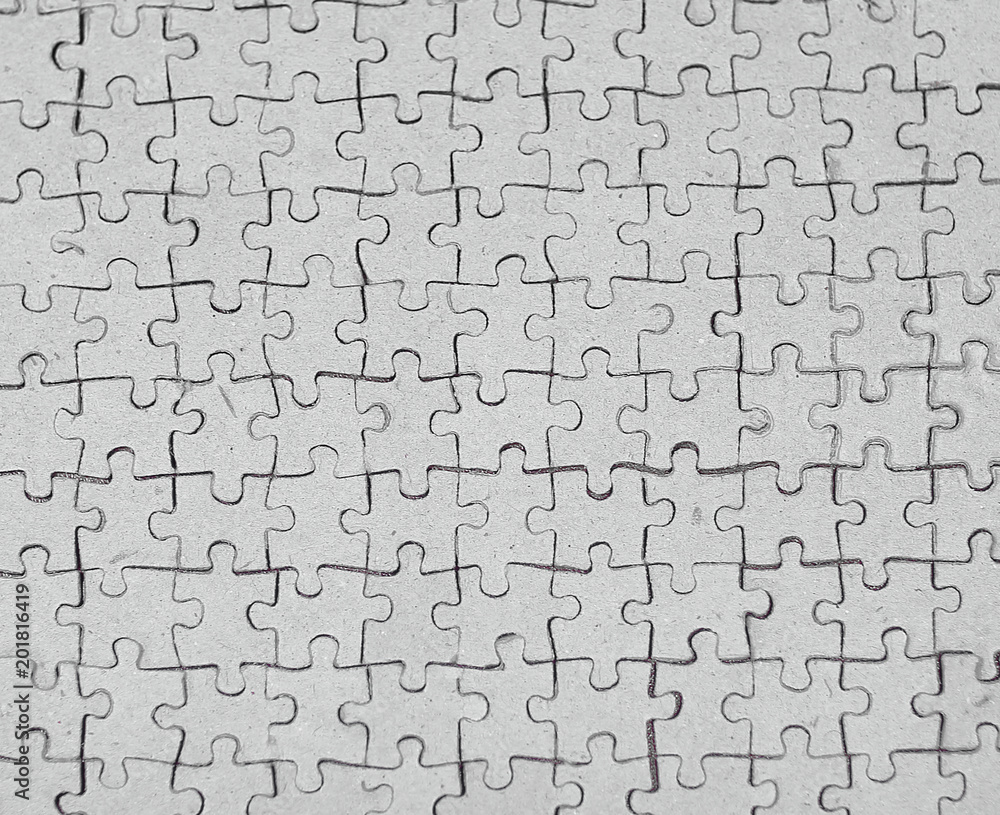 close up. blank card collected from puzzle pieces on gray background close up. blank card collected from puzzle pieces on gray background
