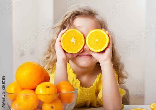 Child with oranges