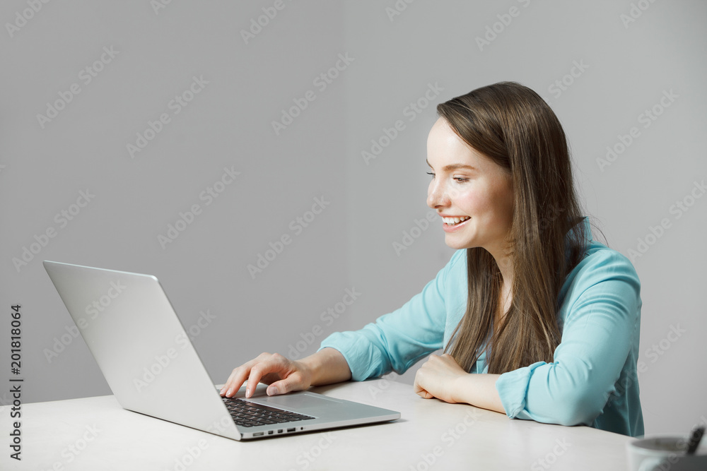 Girl in classic shirt sits at laptop and smile Girl in classic shirt sits at laptop and smile