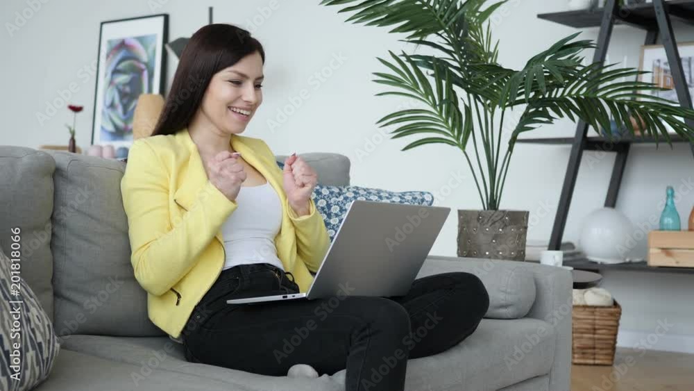 Excited Woman Celebrating Success, Working on Laptop Excited Woman Celebrating Success, Working on Laptop