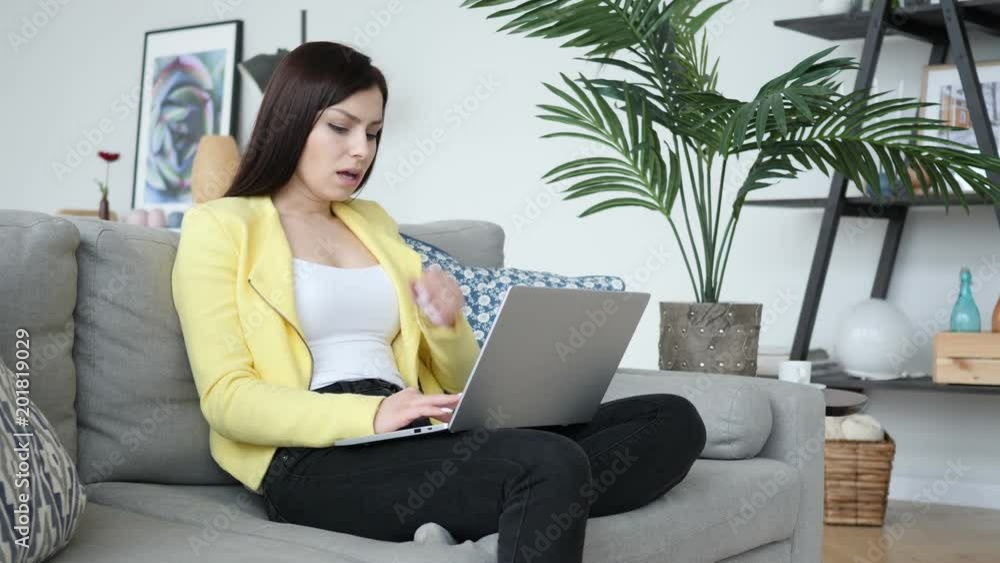 Sick Creative Woman Coughing while Sittting on Sofa and Typing on Laptop Sick Creative Woman Coughing while Sittting on Sofa and Typing on Laptop
