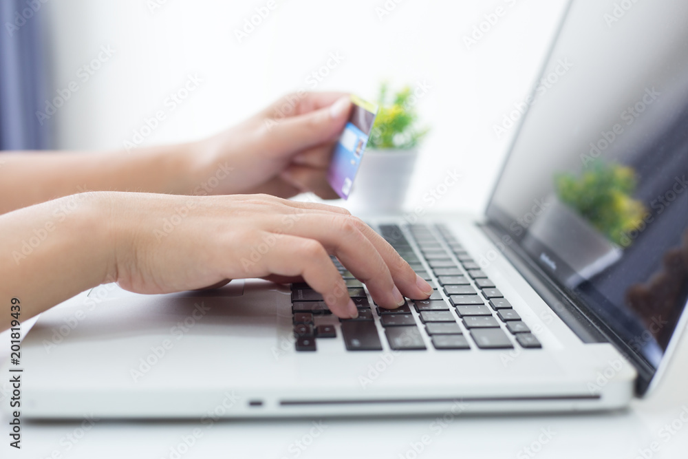 Hands holding credit card and using laptop. Online shopping Hands holding credit card and using laptop. Online shopping