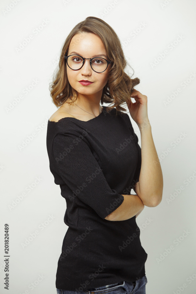 portrait of stylish woman in business look, wears black clothes and round spectacles, has a serious expression, stands on white isolated background. portrait of stylish woman in business look, wears black clothes and round spectacles, has a serious expression, stands on white isolated background.