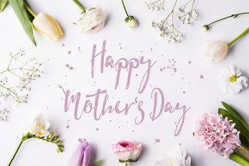 Happy mothers day composition. Flowers on white background. Studio shot.
