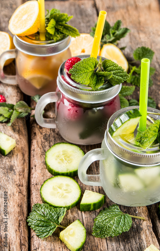 Fresh drink, cucumber, lemon and raspberry cocktail on wooden table. Fresh drink, cucumber, lemon and raspberry cocktail on wooden table.
