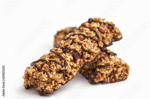 Chocolate granola bars isolated on white background. Healthy sweet dessert snack. Cereal granola bars with nuts and chocolate on a white