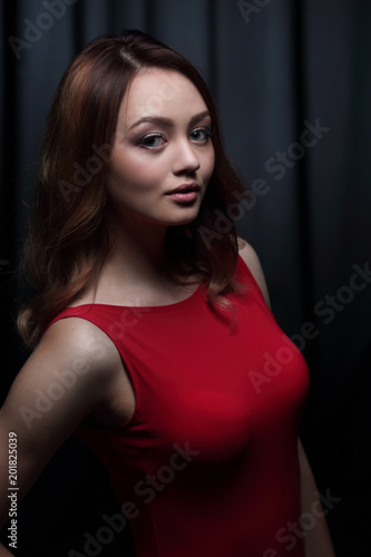 Fashionable young beautiful woman in a red dress © ASDF
