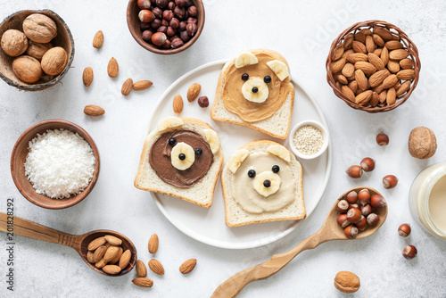 Nut butter banana toast for kids with animal face. Food art, healthy kids meal. Table top view. Healthy eating, healthy lifestyle, kids meal, kids menu, dieting, vegan concept