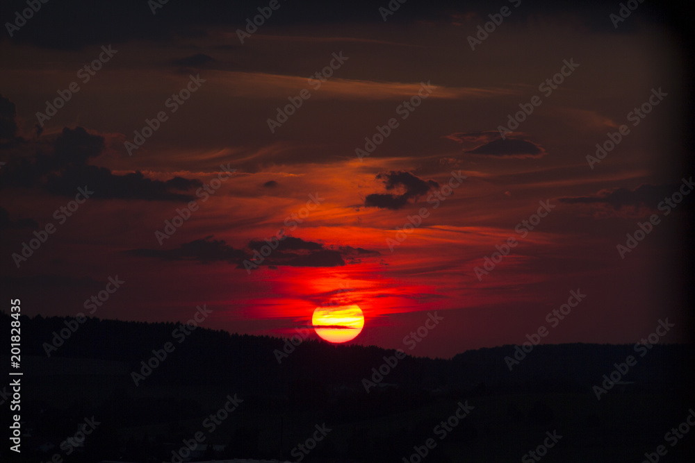 Evening Sky sunset sundown sunny sun dark black clouds purple orange red color colors colorful middle mist daylight in bavaria in germany