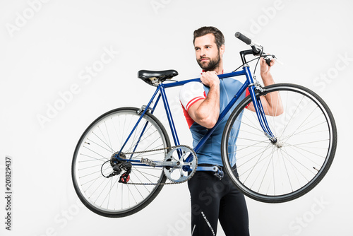 Fototapeta Naklejka Na Ścianę i Meble -  bearded sportsman carrying bike, isolated on white