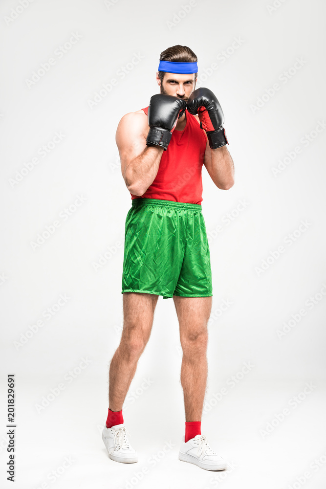 retro sportsman exercising in boxing gloves, isolated on white